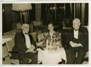 Dr. Hans Luther, ehemaliger Reichskanzler und späterer Botschafter in Washington, D.C., mit zwei weiteren Passagieren bei einem Getränk im Salon des Hochseepassagierdampfers "Bremen"