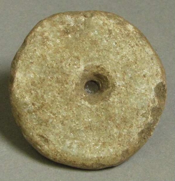 pierced stone disc