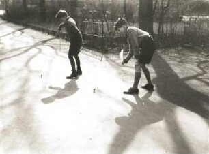 Jungen beim Kreiselspielen auf einer Dorfstraße