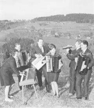 Musizieren mit Instrumenten des VEB Klingenthaler Harmonikawerke vor der Kulisse des Vogtlandes