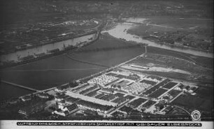 Dresden-Friedrichstadt. Städtischer Vieh- und Schlachthof gegen Elbe mit Alberthafen und Kaditzer Brücke (Flügelwegbrücke). Luftbild-Schrägaufnahme von Nordost