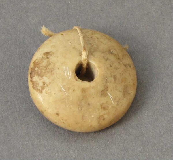 pierced stone disc