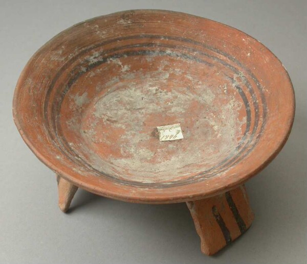 Three-footed clay bowl