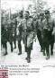 Hitler, Adolf (1889-1945) / Porträt in NS-Uniform mit Parteigenossen auf dem Weg nach Harzburg, mit Bildlegende 'Wir übernehmen die Macht'