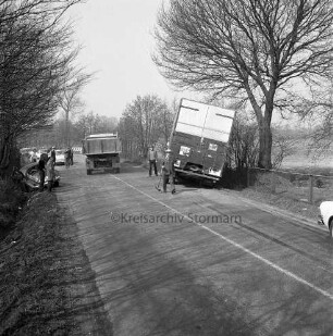 Verkehrsunfall: Landstraße zwischen Hammoor und Bargteheide: Langehorst / Lohe: Kollision eines VW-Käfer mit einem Lkw: rechts verunglückter Lkw im Straßengraben: links Unfall-Pkw: daneben mehrere Polizisten, Helfer und Zuschauer: hinten links vorbeifahrender Lkw: links daneben mehrere parkende Pkws: rechts und links Bäume und Büsche