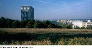 Blick von einer Wiese oberhalb der Michelangelostraße mit Wohnhochhaus zum Stadtzentrum
