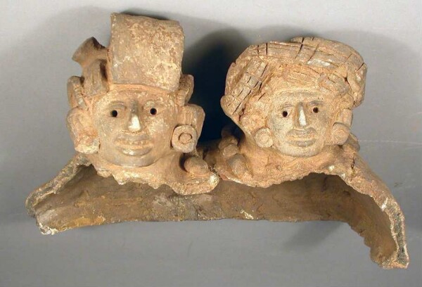 Fragment of a clay lid with clay heads