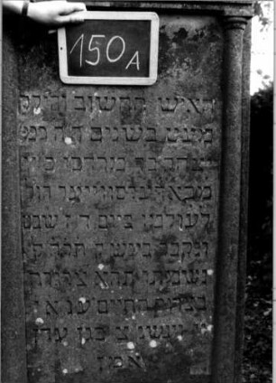 Grabstein 150 (Index: 100111306) Material: Sandstein Zustand: gut Maße HxBxT: 171x74x17 cm Beschreibung: ädikulaartige Stele mit Halbsäulen, Giebel mit Verdachung Symbolik: segnende Hände: Grabstein 150A