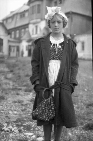 Portrait einer jungen Frau, vor einer Bergwirtschaft stehend