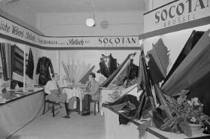 Zwei rauchende Männer in der Sitzecke des Standes der Mechanischen Weberei Salach J. H. Neuburger GmbH Salach sowie der Socotan Brüssel auf der Leipziger Herbstmesse 1955