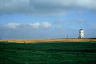 Blick vom Ort über ein Feld, Wasserturm