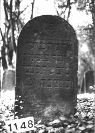 Grabstein 1148 (Index: 99898169) Material: Sandstein Zustand: unten angewittert Maße HxBxT: 95x62x9 cm Beschreibung: Stele mit Rundbogenabschluss: Grabstein 1148