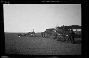 Nicht identifizierbare Ortschaft in Nordfrankreich oder Belgien: Soldaten auf einem weiten Feld beim Anwerfen der Propeller bei 3 Doppeldeckern mit Tatzenkreuz am Rumpf ("Jagdstaffel Czermak")