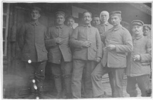 Foto von Verwundeten und Sanitätern vor dem Sanitätsunterstand des Bayerischen Infanterie-Regiments 189 am Fuße des Krähenberges