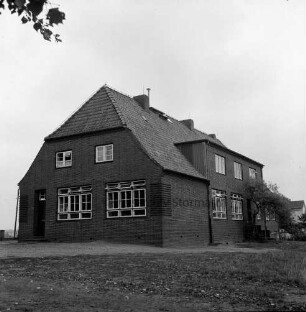 Volksschule: rechts davor Bäume: vorn Rasen
