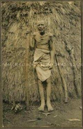Alter afrikanischer Mann mit Stock