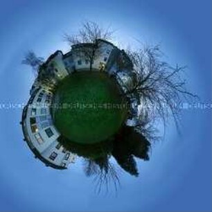 Fotomontage einer Häuserzeile mit Wiese, verzerrt zu einer Kugel (Sonderthema: Fußball-Fieber)