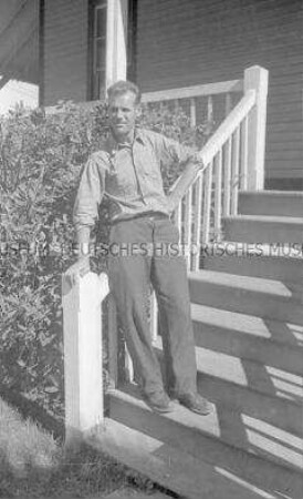 Selbstversenkung des Hochseepassagierdampfers "Columbus" am 19. Dezember 1939, Besatzungsangehörige im Internierungslager auf Angel Island, Kalifornien, Mann auf einer Holztreppe