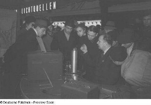 Besucher vor einem Messestand