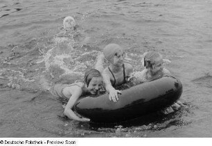 Kinder beim Baden mit einem Autoreifen