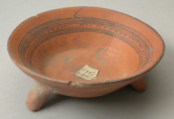 Three-footed clay bowl