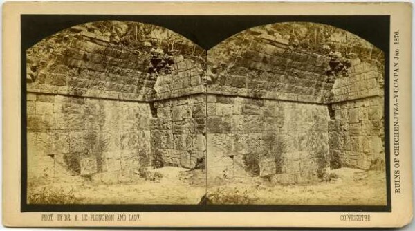 A collapsed room whose walls are decorated with reliefs.