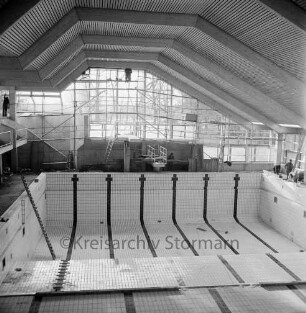 Hallenbad Bad Oldesloe: Konrad-Adenauer-Ring: Innenarbeiten an der Fensterfassade, vorne das Schwimmbecken