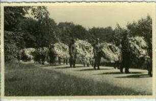 Wehrmachtssoldaten mit Kränzen bei der Beisetzung Wilhelms II. im Park von Schloss Doorn