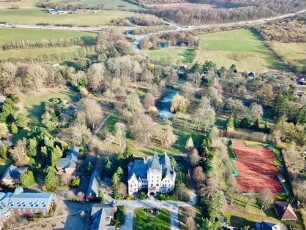 Tremsbüttel: Luftbild des Schloßhotels (Herrenhaus): Frontseite, dahinter Park, im Hintergrund Bundesautobahn 21