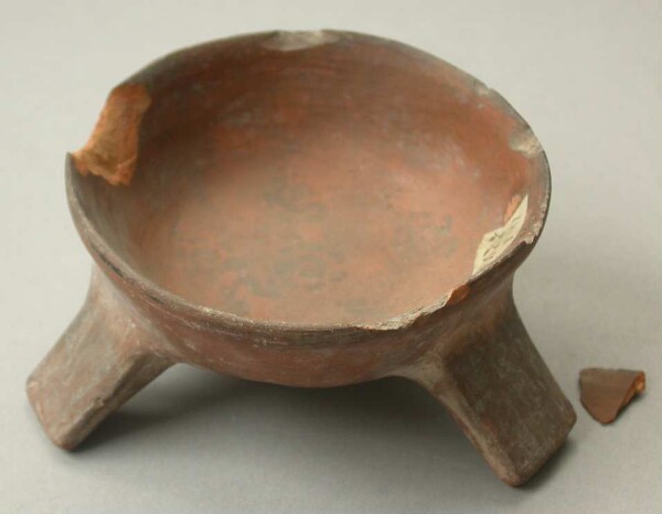 Three-footed clay bowl