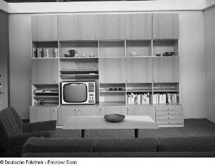 Couchtisch : Wohnzimmermöbel (1972; Möbelkombinat Nord (MKN)). Ansicht mit Anbauwand und Couchtisch mit Sessel