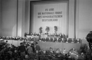 Konstituierende Sitzung der Provisorischen Volkskammer der DDR im Gebäude der Deutschen Wirtschaftskommission in der Leipziger Straße : Blick auf die Bühne mit den Politikern