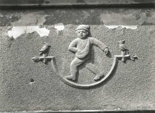 Dresden-Pieschen, Hubertusstraße 53/57. Wohnhauszeile (um 1928). Figürlicher Schmuck. Sämann mit Vögeln (Nr. 53, 1. Obergeschoss)