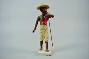 Tonfigur eines Bauers mit Hut und Handpflug