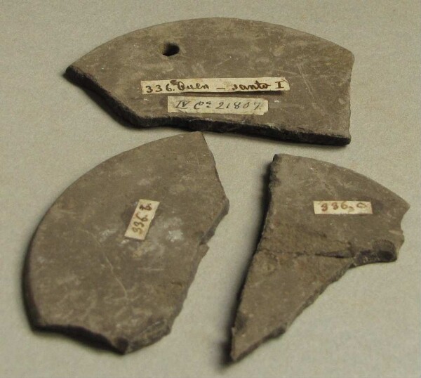 Fragments of a decorative slate disc