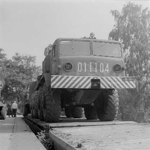 Verladen von Militärtechnik der 1. Gardepanzerarmee im Bf. Dresden-Klotzsche. Sattelzugtieflader bei Auffahrt von Laderampe auf Flachwagen