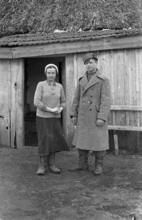 Zweiter Weltkrieg. Zur Einquartierung. Sowjetunion. Junges russisches Paar vor einer Bauernhütte