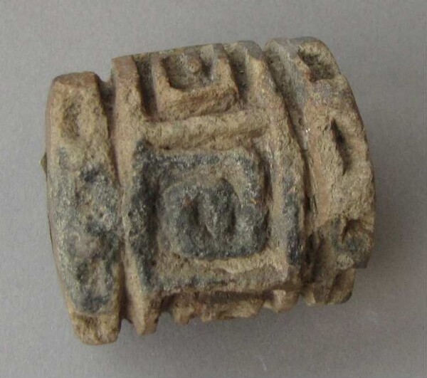 Scroll stamp made of clay (fragment)