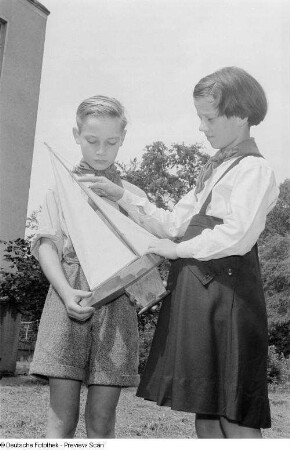 Zwei Kinder mit einem Schiffsmodell