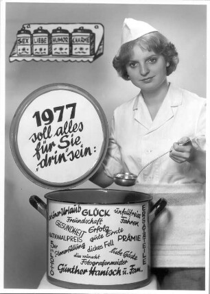 Grußkarte zum Jahreswechsel 1976/1977 : 1977 soll alles für Sie "drin" sein: schöner Urlaub, Glück, Freundschaft, Gesundheit, Nationalpreis, 5er im Lotto, Planerfüllung, Erfolg, gute Ernte, dickes Fell, unfallfreies Fahren, Prämie, liebe Gäste, Ersatzteile. Grußkarte des Fotografen aus Roßwein zum Jahreswechsel 1976/1977 (mit junger Frau am Kochtopf)