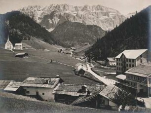 Wolkenstein in Gröden. Südtirol. Italien. Ansicht des Ortes. Links im Bild die Pfarrkirche St. Maria Himmelfahrt. Im Hintergrund des Bergmassiv der Sellagruppe
