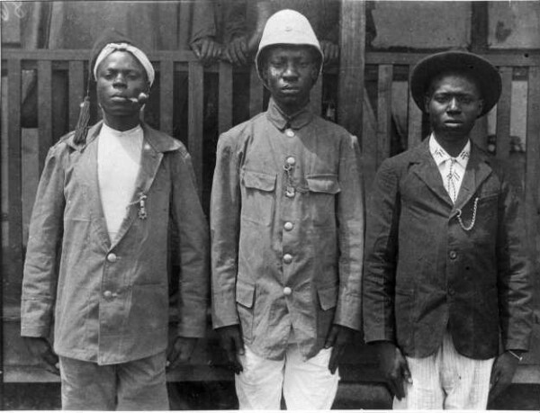 Three African men in apell posture (overseer ?)