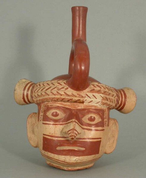 Portrait head with stirrup spout