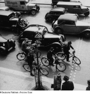 Berlin. Kraftfahrzeuge und Radfahrer, Unter den Linden/Friedrichstraße wartend an Kreuzung