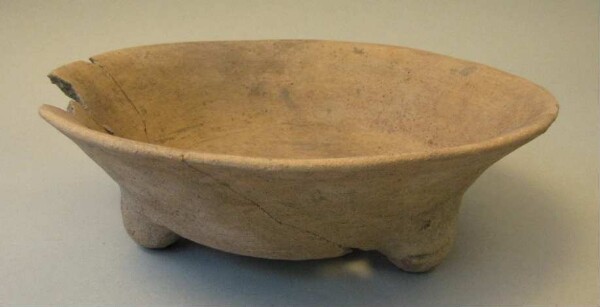 Three-footed clay bowl