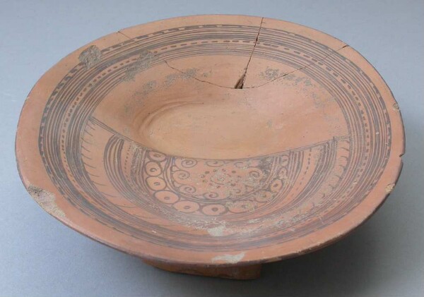 Three-footed clay bowl