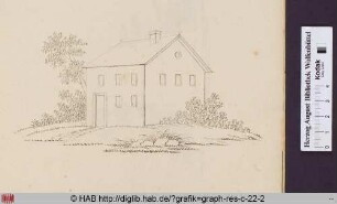 Haus mit Baum und Buschwerk.