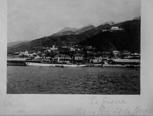 Der Hafen von La Guaira : Am Hafen von La Guaira. Mehrere Schiffe befinden sich an den Anlegestellen. Im Hintergrund ist Küstensiedlung erkennbar