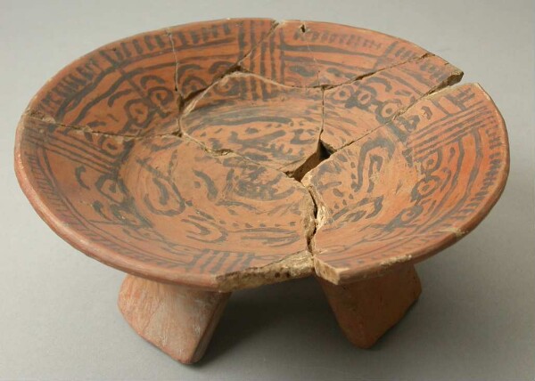 Three-footed clay bowl