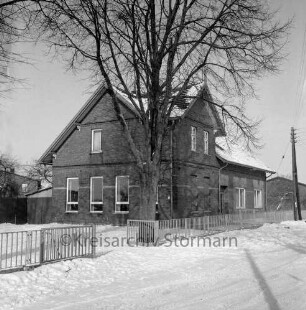 Volksschule: gemeinsame zweiklassige Dorfschule mit Kronshorst: davor Schulhof mit Baum und Zaun: Winter